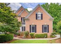 Charming brick home with black shutters and manicured landscaping at 7071 Glen Cove Ln, Stone Mountain, GA 30087