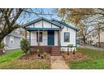 Charming home with a welcoming front porch and beautifully landscaped front yard at 819 Humphries St, Atlanta, GA 30310