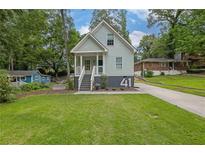 Charming light blue two-story home with a welcoming front porch and landscaped front yard at 41 Spring Nw Ln, Atlanta, GA 30314