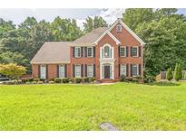 Beautiful brick home with a manicured lawn and mature trees in a desirable neighborhood at 2260 Cobble Creek Ln, Grayson, GA 30017