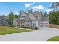 Beautiful home with a long driveway, three-car garage, and a combination of stone and siding at 783 Phil Haven Ln, Kennesaw, GA 30152