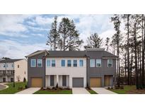 Beautiful townhome exteriors with modern color schemes and private driveways offer curb appeal at 1726 Gunnin Nw Trce # 231, Atlanta, GA 30318