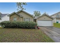 Charming one-story home featuring stone accents, a two-car garage, and lush green landscaping at 2374 Brandenberry Ct, Decatur, GA 30034