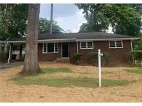 Charming brick ranch-style home with a covered carport and a traditional front yard at 4925 Sugar Valley Sw Rd, Mableton, GA 30126