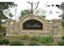 Stone entrance sign for Carillon subdivision with mature landscaping at 1128 Carillon Dr, Conyers, GA 30013