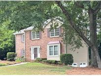 Charming two-story brick home with mature landscaping, featuring a welcoming front facade and well-maintained lawn at 2872 Bentwood Dr, Marietta, GA 30062
