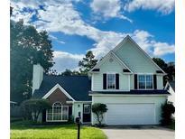 Charming two-story home featuring a well-manicured lawn, attached two-car garage, and inviting front door at 2915 Camelot Woods Dr, Lawrenceville, GA 30044