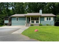 Charming single-story home featuring a screened porch, front porch, and inviting curb appeal at 259 Gramling Trl, Canton, GA 30114