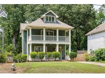 Charming two-story home featuring a double-decker porch and a well-maintained lawn at 2876 White Oak Dr, Decatur, GA 30032