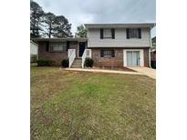 Traditional two-story home with brick and vinyl siding and a well-maintained front yard at 213 Peartree Ln, Riverdale, GA 30274