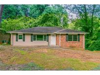 Charming ranch-style house with brick accents and a lush, green surrounding landscape at 2582 Springdale Sw Rd, Atlanta, GA 30315