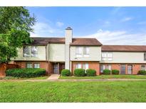 Charming townhouse featuring a brick foundation, siding and manicured bushes, under a sunny blue sky at 3184 Nectarine Cir, Decatur, GA 30034