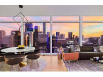 Modern living and dining area with stylish furniture and expansive city views through large windows at 45 Ivan Allen Jr Nw Blvd # 2505, Atlanta, GA 30308