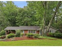 Charming single-story brick home with a covered carport and lush landscaping at 1215 Vista Leaf Dr, Decatur, GA 30033