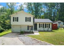Charming home featuring a blend of traditional and modern design with lush greenery surrounding the property at 3012 Dempsey Pl, Lawrenceville, GA 30044