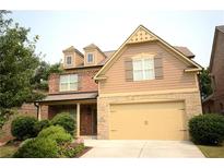 Charming two-story home with a blend of brick and siding, featuring a well-manicured lawn at 560 Tuscany Walk Ln, Lawrenceville, GA 30043