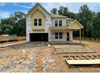 Two-story home exterior view showcases construction with a covered porch and a two-car garage at 731 Crest Line Trl, Powder Springs, GA 30127