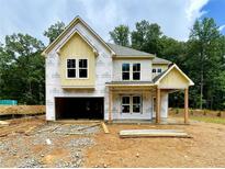 New construction featuring Hardie siding, a welcoming front porch, and an attached two-car garage at 731 Crest Line Trl, Powder Springs, GA 30127
