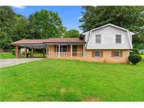 Charming home featuring a well-manicured lawn and a convenient covered carport at 2135 Knighton Dr, Atlanta, GA 30349