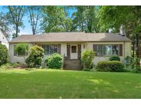 Charming one-story home with a well-manicured front yard and mature trees at 251 Beverly Ne Rd, Atlanta, GA 30309