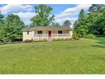 Charming ranch home with a welcoming front porch and large manicured front lawn at 19 Quail Hollow Ct, Dallas, GA 30157