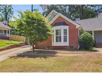 Charming brick home featuring a well-manicured lawn and a beautiful bay window at 2611 Leeshire Ct, Tucker, GA 30084