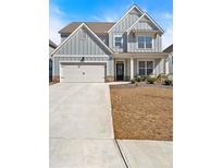 Charming two-story home with a two-car garage, covered porch and attractive neutral gray siding at 90 Citrine Way, Acworth, GA 30101