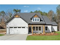Beautiful new construction home with a white exterior, two-car garage and appealing, craftsman-style design at 2080 Cactus Ln, Cumming, GA 30040