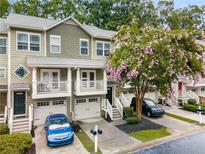 Charming townhouse featuring a one car garage and a lovely crape myrtle in the front yard at 1529 Liberty Nw Pkwy # 2314, Atlanta, GA 30318