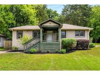 Charming one-story home with a well-manicured lawn and inviting front porch at 1770 Rockland Se Dr, Atlanta, GA 30316