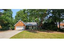 Charming brick home with attached garage and a well-maintained lawn at 2123 Condor Dr, Lawrenceville, GA 30044