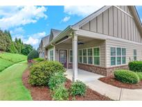 Charming home with covered porch, beautiful landscaping, and well-maintained lawn and walkway at 2384 Tree Arbor Way, Marietta, GA 30064