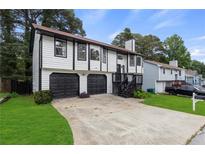 Charming two-story home with a well-maintained lawn and a two-car garage at 6322 Phillips Creek Dr, Lithonia, GA 30058
