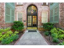 Charming brick building entrance featuring an arched doorway, double doors, and landscaped walkway at 124 Lafayette Ne Dr # 4, Atlanta, GA 30309