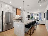 Beautiful modern kitchen with stainless steel appliances, marble island, and open floor plan at 230 New St # 2201-4, Decatur, GA 30030