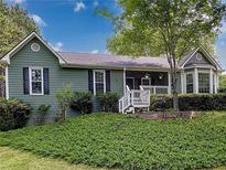Charming single-Gathering home featuring a cozy porch and a well-maintained lawn at 4812 Shallow Creek Nw Dr, Kennesaw, GA 30144