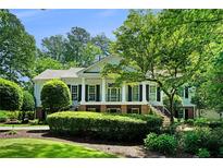 Stately home with manicured lawn, elegant columns, and dual staircase at 5545 Cross Gate Ct, Atlanta, GA 30327