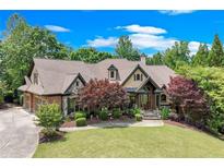 Charming two-story home with beautiful lawn and landscaped yard with brick and stone exterior accents at 5623 Brendlynn Dr, Suwanee, GA 30024