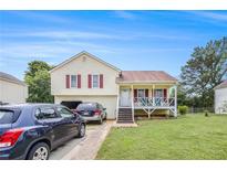 Charming two-story home with a cozy front porch, attached garage, and well-maintained lawn at 453 Villa Rosa Rd, Temple, GA 30179