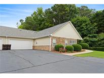 Charming home featuring stone accents, well-maintained landscaping, and an attached two-car garage at 3734 Villa Springs Cir, Powder Springs, GA 30127