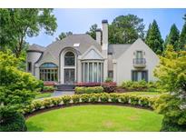 Stunning two-story home with manicured lawn, lush landscaping and stately architecture at 115 Cross Roads Ct, Atlanta, GA 30327