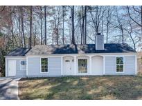 Charming single-story home with light blue siding, white trim, and a well-maintained front yard at 2216 Marbut Farms Trce, Lithonia, GA 30058
