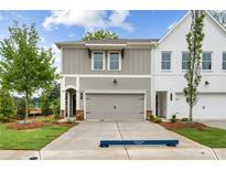 Charming townhome featuring a two-car garage, manicured lawn and traditional architecture at 101 Priestwood Ln, Acworth, GA 30102