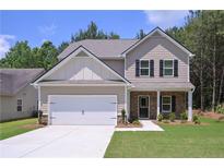 Charming two-story home showcasing a well-manicured lawn, a two-car garage, and a welcoming stone-accented entrance at 48 Beaver Pt, Villa Rica, GA 30180