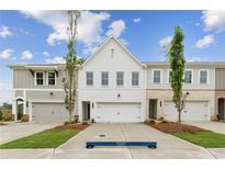 Attractive new townhomes featuring attached garages, varied exterior finishes, and professionally landscaped front yards at 105 Priestwood Ln, Acworth, GA 30102