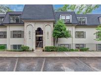 Charming condo building with black roof, neutral siding, brick accents, and well-manicured landscaping at 30 Chaumont Nw Sq, Atlanta, GA 30327
