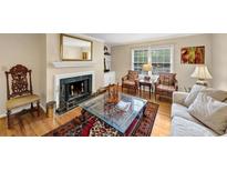 Cozy living room featuring a fireplace with decorative mantle, complemented by hardwood floors and comfortable seating at 30 Chaumont Nw Sq, Atlanta, GA 30327
