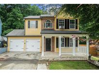 Charming two-story home with a welcoming front porch and a two-car garage, perfect for suburban living at 5292 Windfield Glen Nw Ct, Lilburn, GA 30047