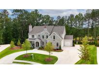 Beautiful stone home with a circular driveway and professionally landscaped front yard at 126 Owens Mill Pl, Canton, GA 30115