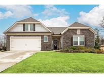 Charming single-Gathering home featuring a stone facade, two-car garage, and well-manicured lawn at 3430 Summerpoint Xing, Cumming, GA 30028